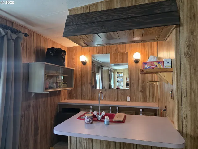 a kitchen with stainless steel appliances kitchen island granite countertop a refrigerator and a stove top oven