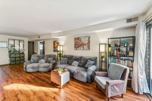 a living room with furniture and a book shelf
