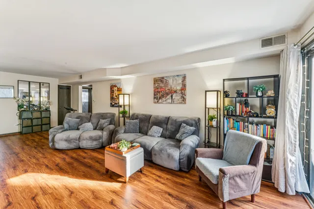a living room with furniture and a book shelf