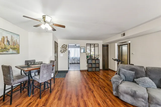 a living room with furniture and wooden floor