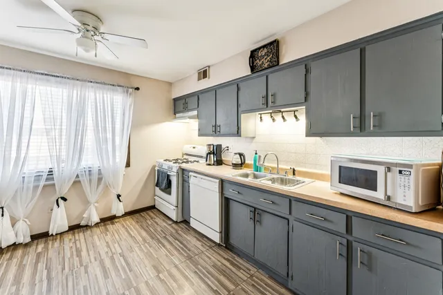 a kitchen with a sink window and cabinets