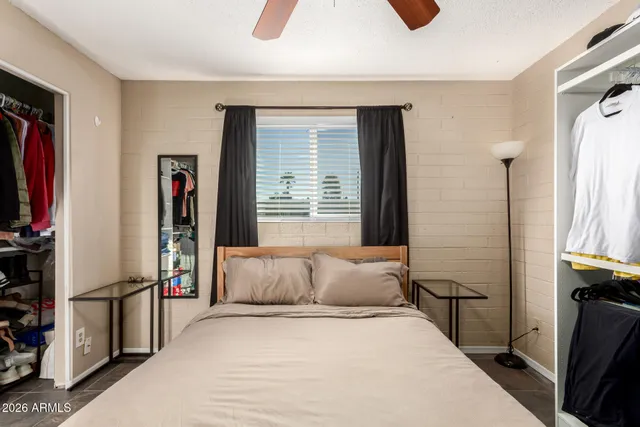 a bedroom with a bed and a desk