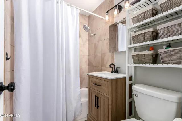 a view of a hallway with closet and a window