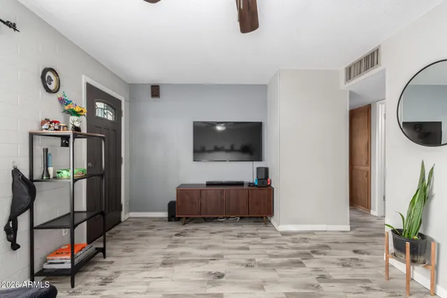 a living room with furniture and a clock