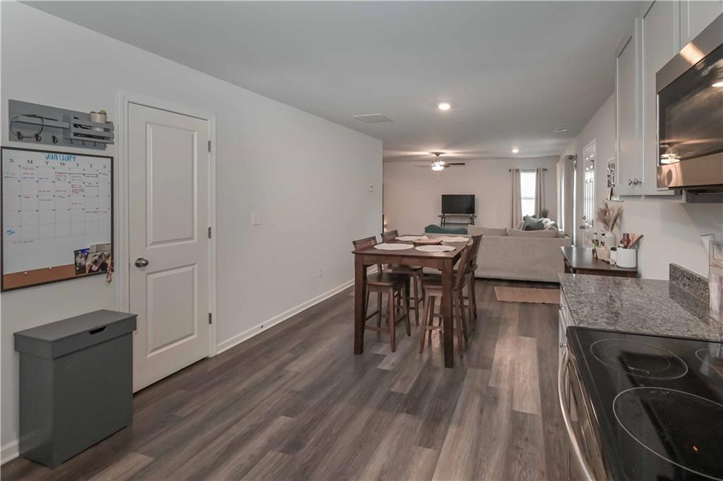 294 Muskogee Drive Dallas, GA 30132 - Photo 19 of 32 a view of a kitchen with kitchen island granite countertop wooden floors and a sink