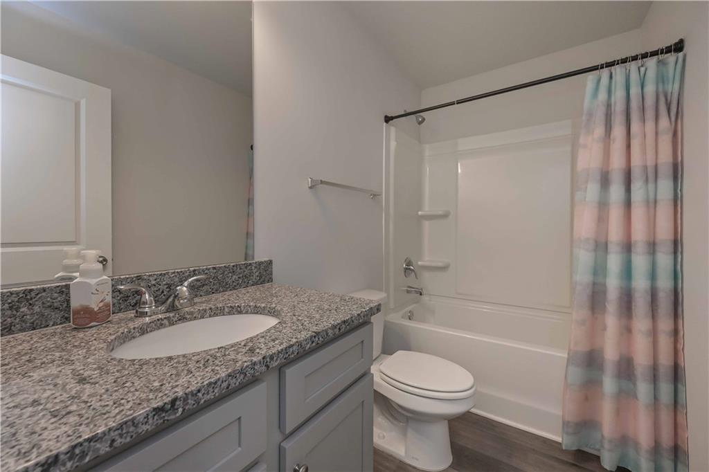294 Muskogee Drive Dallas, GA 30132 - Photo 20 of 32 a bathroom with a granite countertop sink toilet and shower