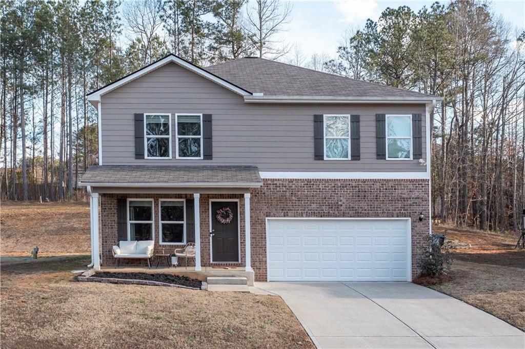294 Muskogee Drive Dallas, GA 30132 - Photo 2 of 32 a front view of a house with a yard and garage