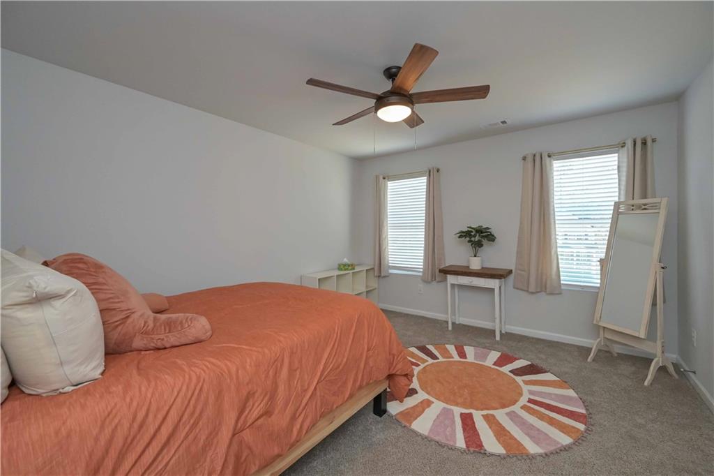 294 Muskogee Drive Dallas, GA 30132 - Photo 21 of 32 a bedroom with a bed and a chandelier