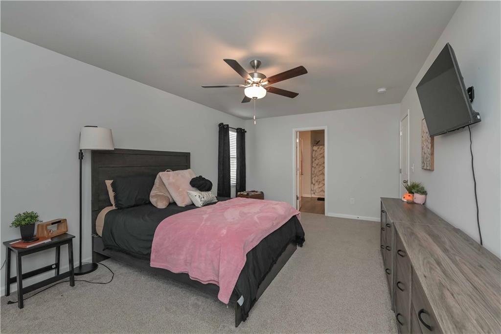 294 Muskogee Drive Dallas, GA 30132 - Photo 28 of 32 a bedroom with a bed and a flat tv screen on dresser