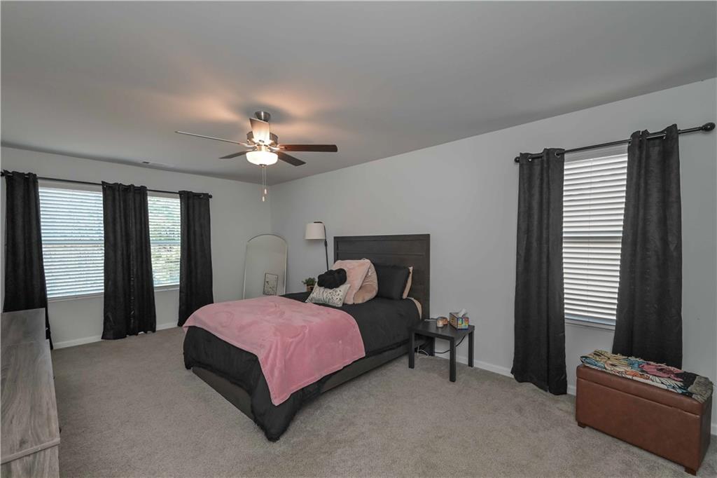294 Muskogee Drive Dallas, GA 30132 - Photo 29 of 32 a bedroom with a bed couch and window