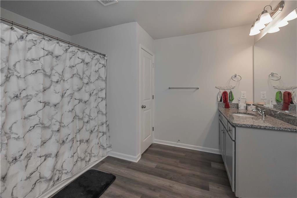 294 Muskogee Drive Dallas, GA 30132 - Photo 32 of 32 a bathroom with a granite countertop sink and a mirror