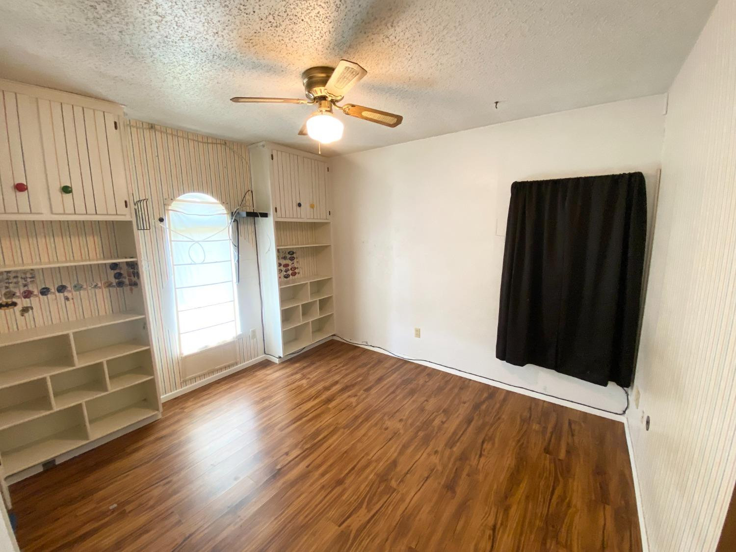 1311 Ave G Abernathy, TX 79311 - Photo 11 of 15 wooden floor in an empty room with a window