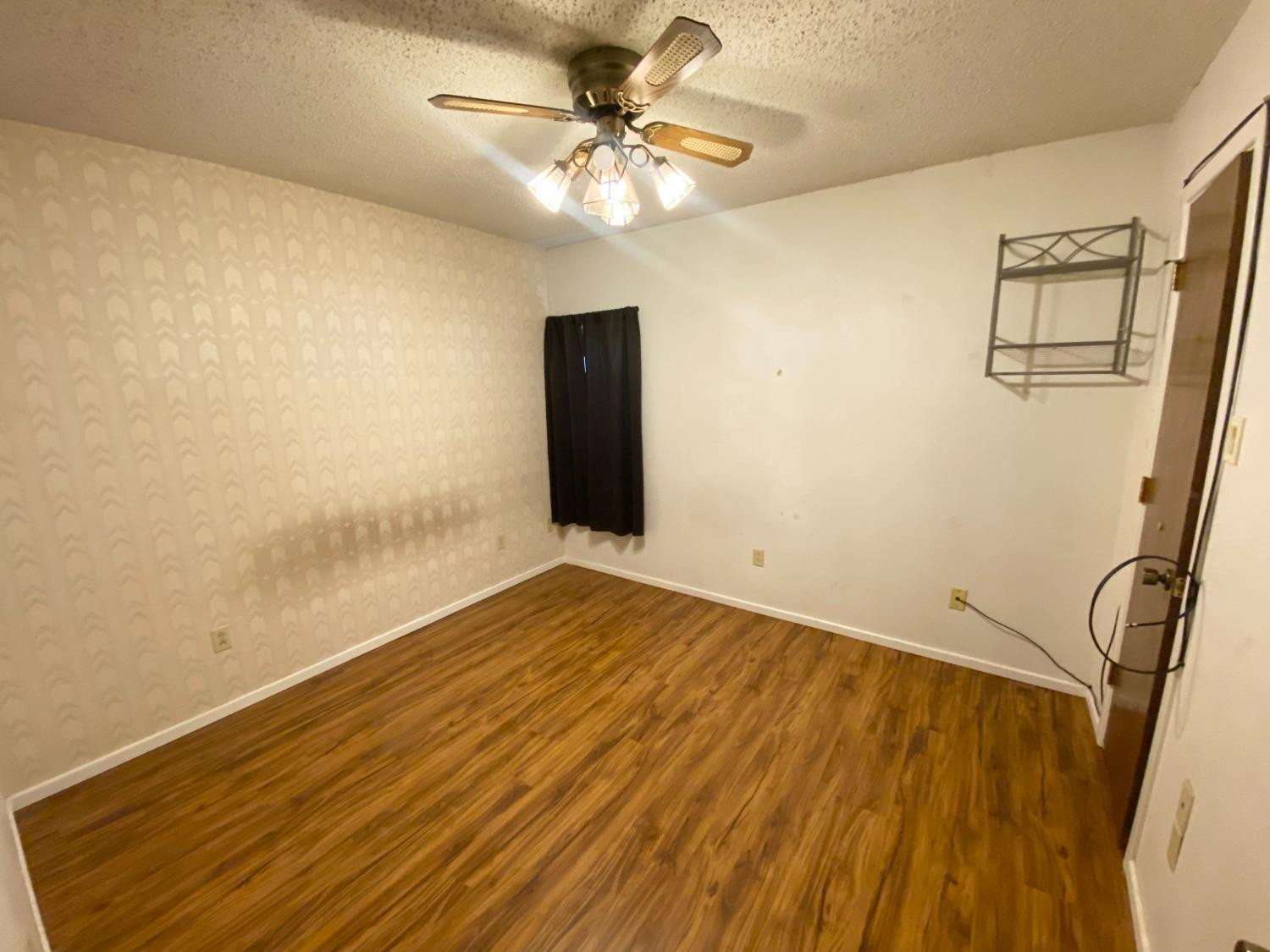 1311 Ave G Abernathy, TX 79311 - Photo 12 of 15 a view of an empty room with a chandelier fan