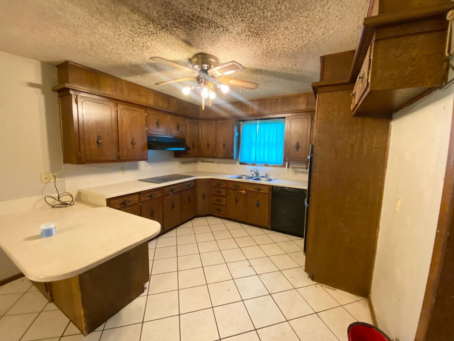 1311 Ave G Abernathy, TX 79311 - Photo 4 of 15 a kitchen with a sink stainless steel appliances a counter top space and cabinets