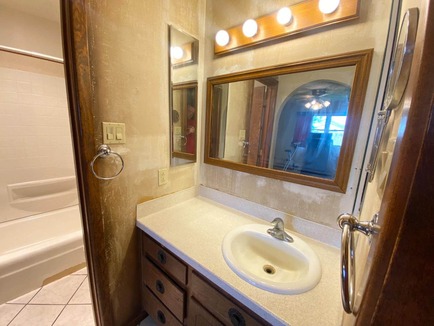 1311 Ave G Abernathy, TX 79311 - Photo 9 of 15 a bathroom with a sink a toilet and a mirror