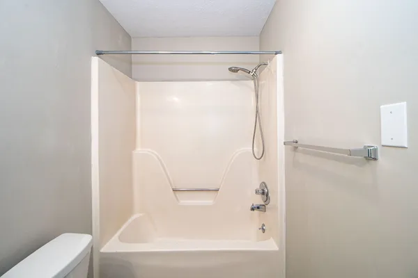 a bathroom with a shower and a bath tub