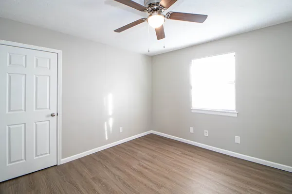 wooden floor in an empty room with a window
