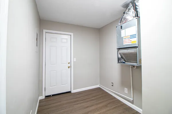 a view of an entryway with wooden floor