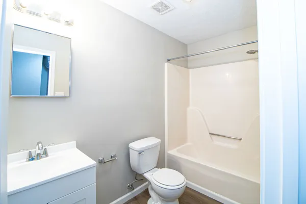 a white toilet sitting next to a bathroom sink