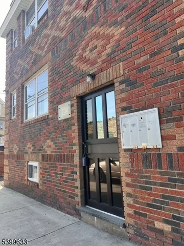 a brick building with a door and a window