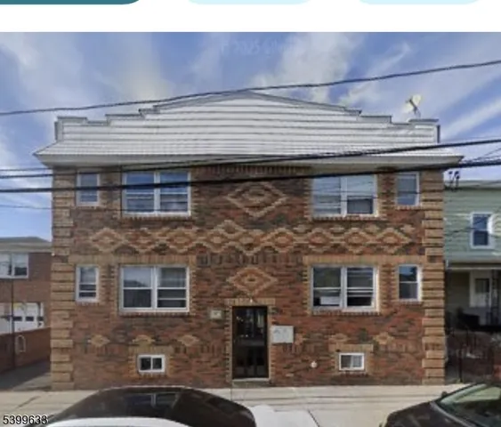 a front view of a building with a brick wall