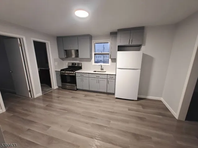 a kitchen with a refrigerator a stove top oven a sink and dishwasher