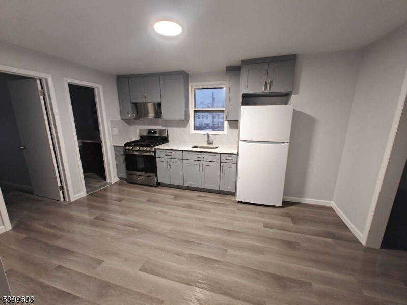 327 Christine Street, Unit 2L Elizabeth, NJ 07202 - Photo 5 of 11 a kitchen with a refrigerator a stove top oven a sink and dishwasher
