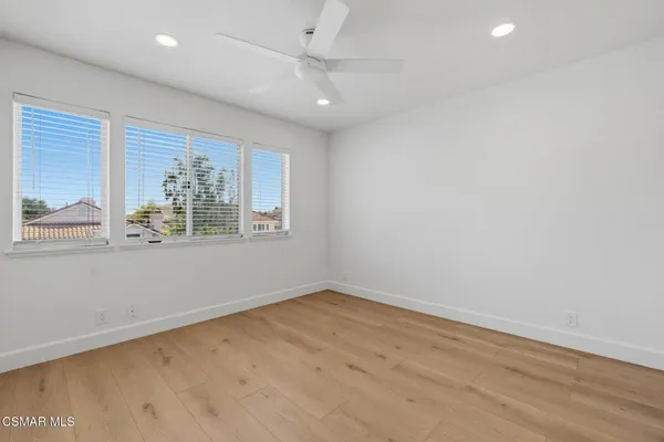 an empty room with windows and closet