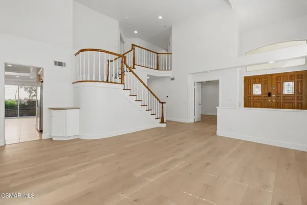 a view of an entryway with wooden floor