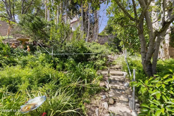 a view of a house with backyard porch and sitting area