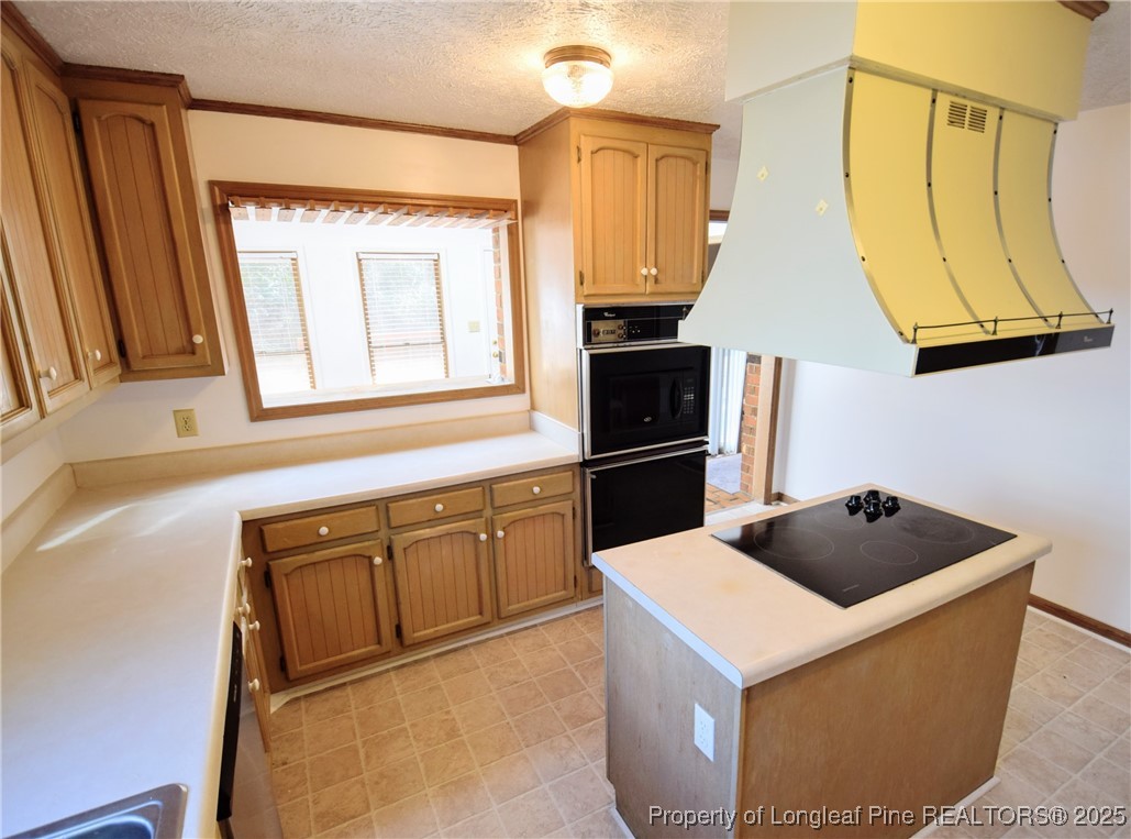 2347 Rolling Hill Road Fayetteville, NC 28304 - Photo 12 of 26 a kitchen with a sink a refrigerator and cabinets