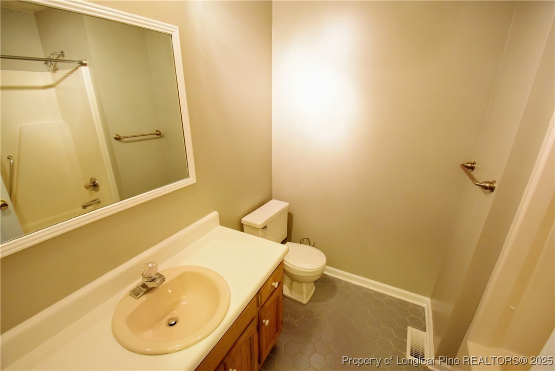 2347 Rolling Hill Road Fayetteville, NC 28304 - Photo 13 of 26 a bathroom with a sink and a mirror