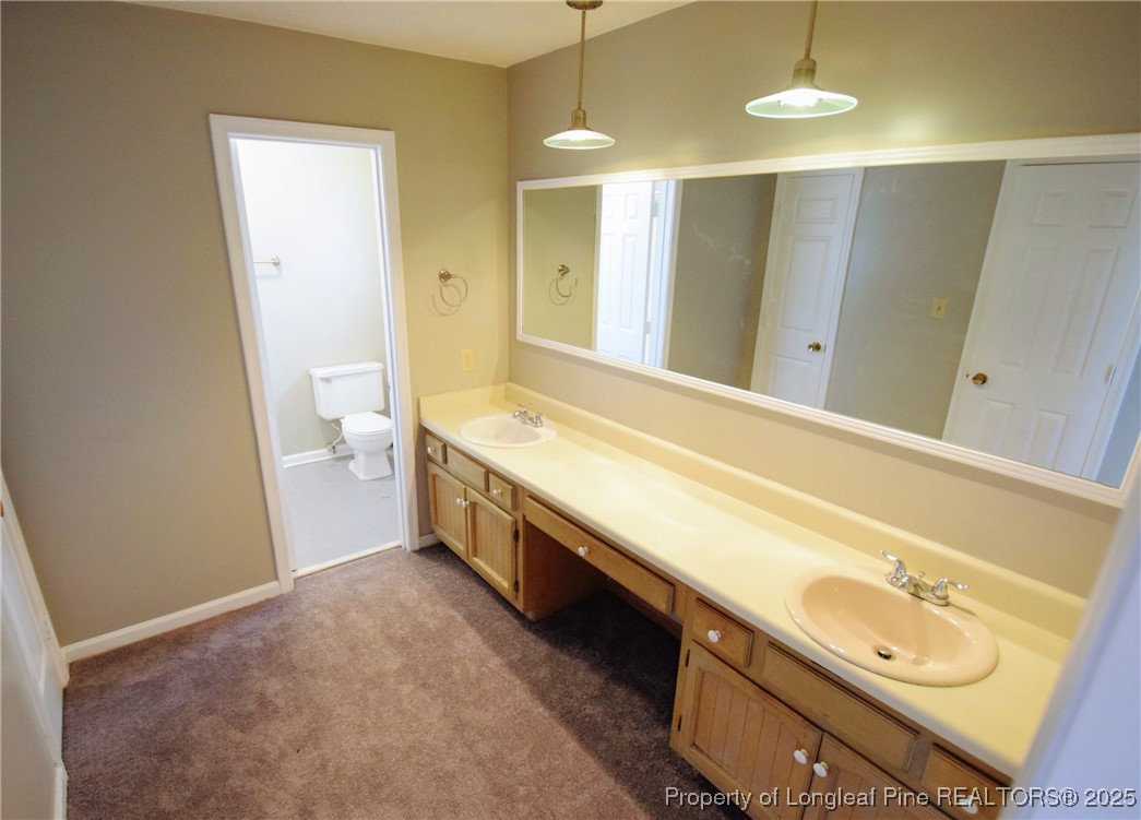 2347 Rolling Hill Road Fayetteville, NC 28304 - Photo 20 of 26 a bathroom with a double vanity sink and a mirror