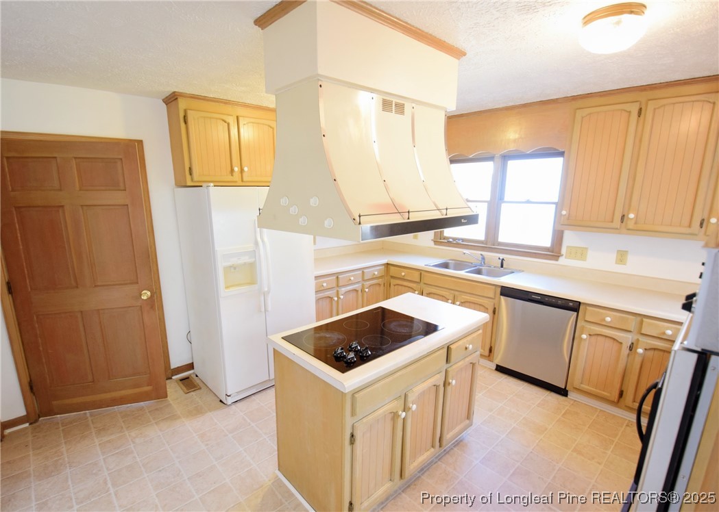 2347 Rolling Hill Road Fayetteville, NC 28304 - Photo 10 of 26 a kitchen with a stove a sink and a refrigerator