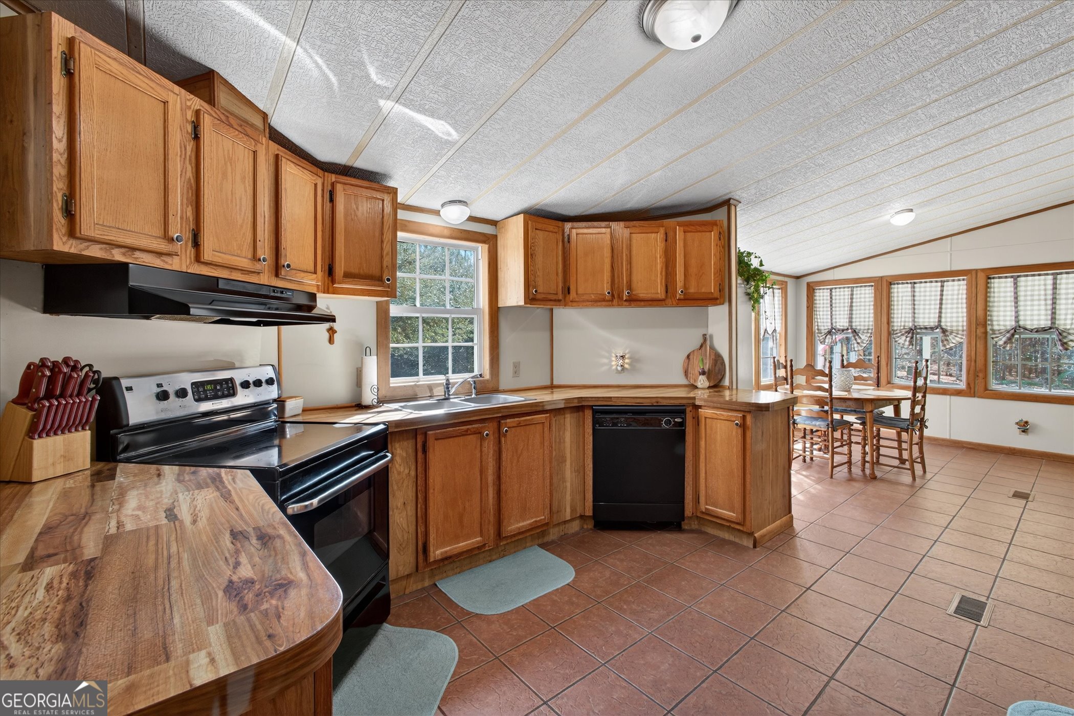 395 Winchester Road Sylvania, GA 30467 - Photo 17 of 60 a kitchen with stainless steel appliances granite countertop a stove a sink dishwasher and a microwave oven with cabinets