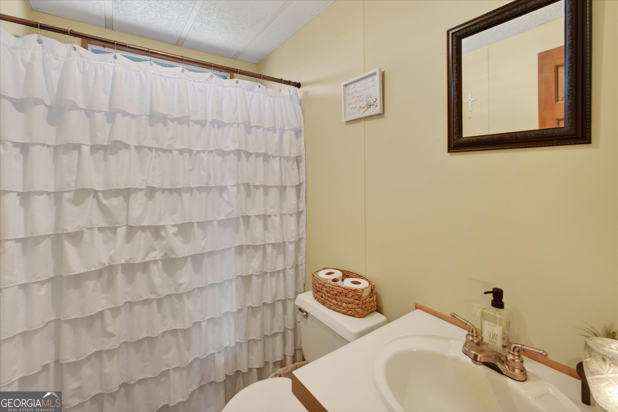 395 Winchester Road Sylvania, GA 30467 - Photo 22 of 60 a bathroom with a sink and a mirror