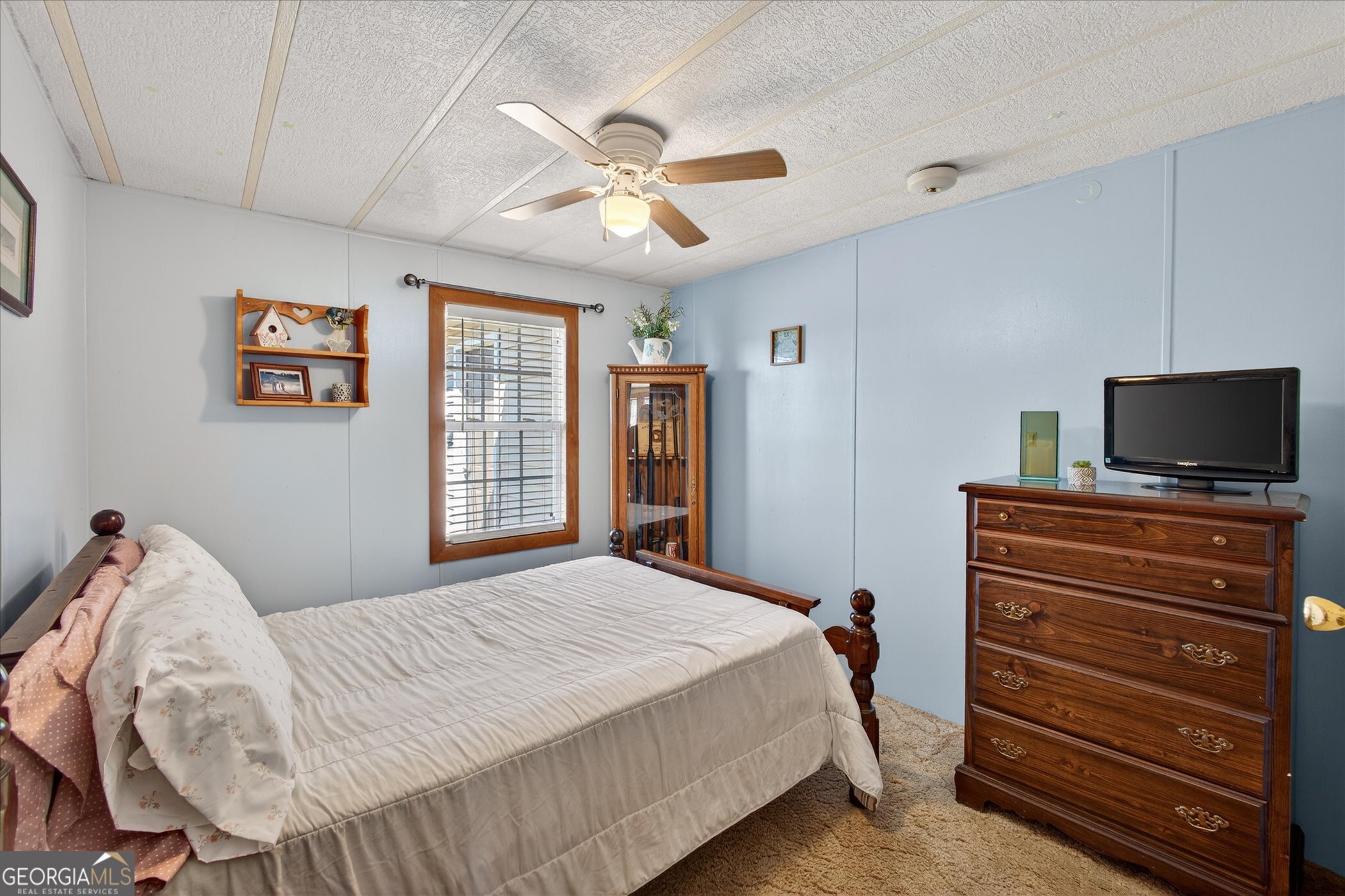 395 Winchester Road Sylvania, GA 30467 - Photo 23 of 60 a bedroom with a bed and a flat screen tv