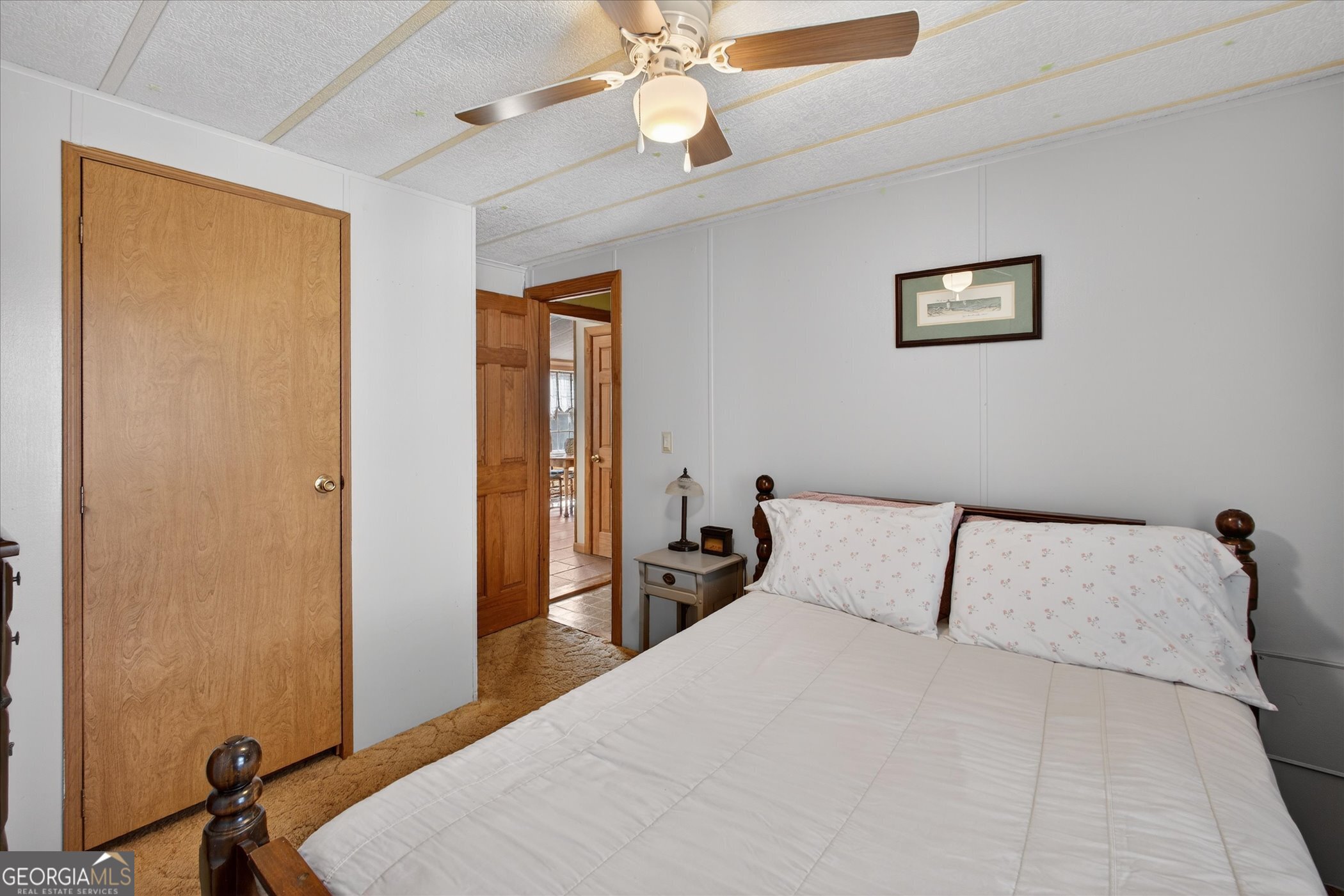 395 Winchester Road Sylvania, GA 30467 - Photo 24 of 60 a bedroom with a bed and a chandelier