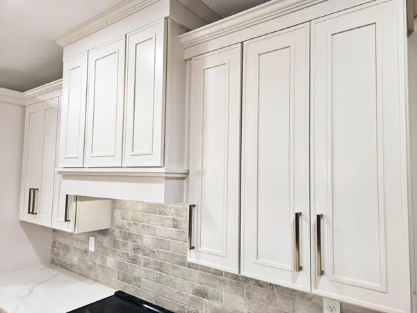 a view of an empty room with large windows