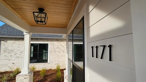 a large white kitchen with a stove a sink dishwasher and a refrigerator