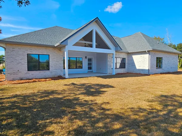 a large kitchen with stainless steel appliances a large counter top a stove and a refrigerator