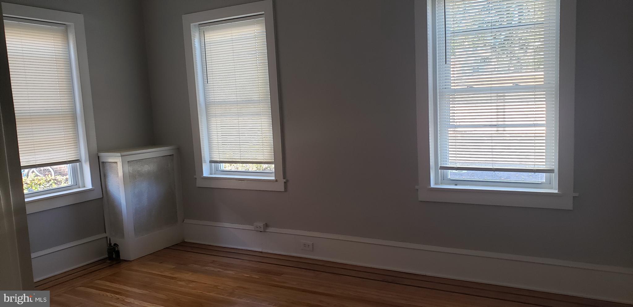 715 Collings Avenue, Unit A Oaklyn, NJ 08107 - Photo 19 of 22 a view of an empty room with wooden floor and a window