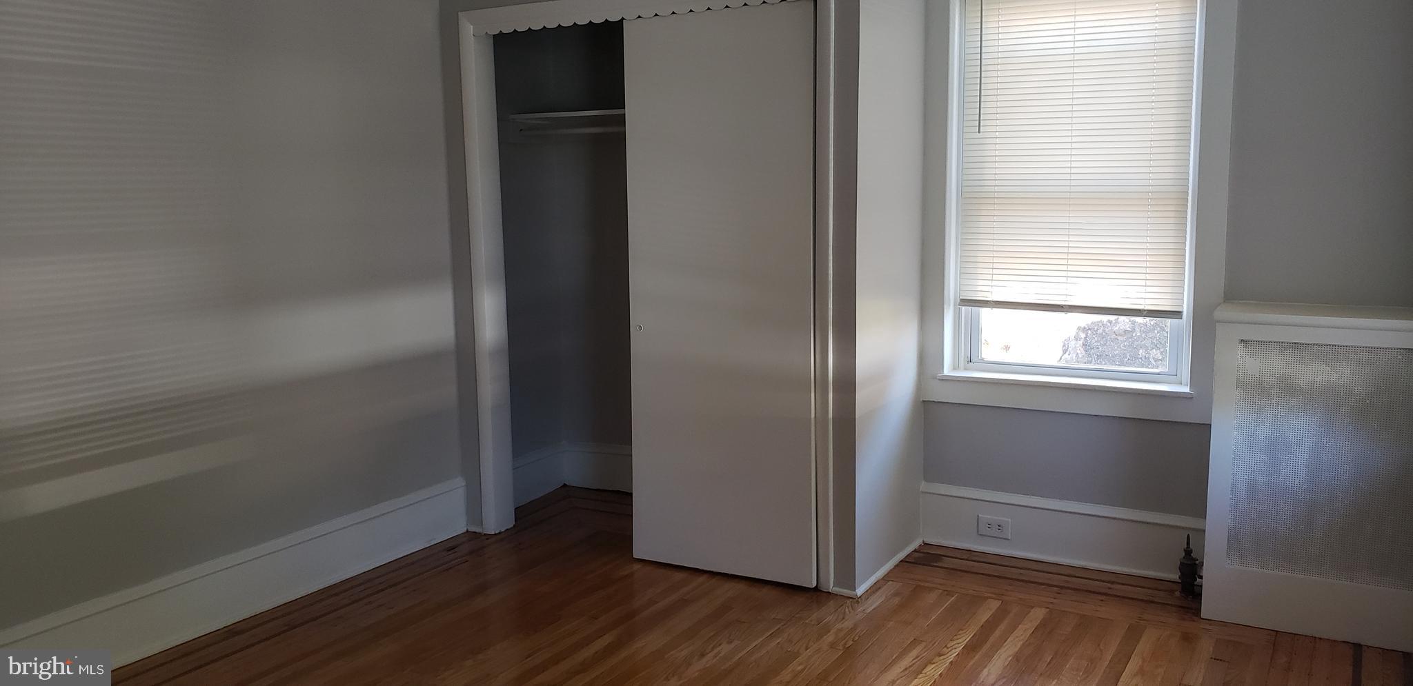 715 Collings Avenue, Unit A Oaklyn, NJ 08107 - Photo 20 of 22 a view of an empty room with wooden floor and a window