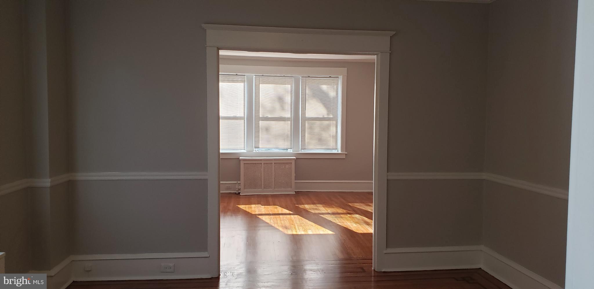 715 Collings Avenue, Unit A Oaklyn, NJ 08107 - Photo 5 of 22 an empty room with wooden floor and a window