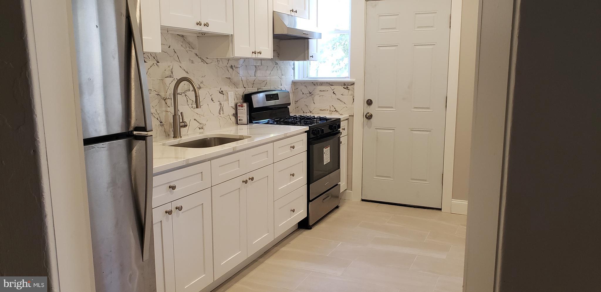 715 Collings Avenue, Unit A Oaklyn, NJ 08107 - Photo 6 of 22 a utility room with cabinets washer and dryer
