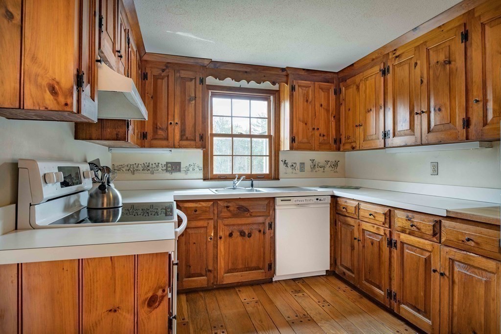 111 Audubon Road Northampton, MA 01053 - Photo 16 of 39 a kitchen with stainless steel appliances granite countertop wooden cabinets a sink and dishwasher a stove with wooden floor