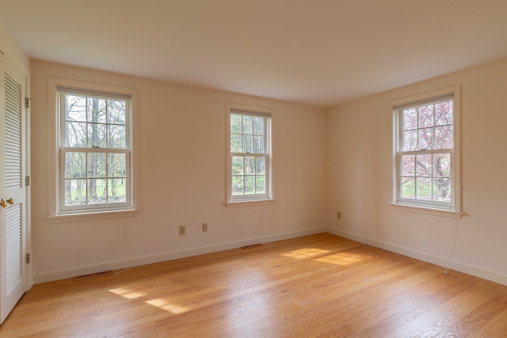 111 Audubon Road Northampton, MA 01053 - Photo 10 of 39 a view of an empty room with wooden floor and a window