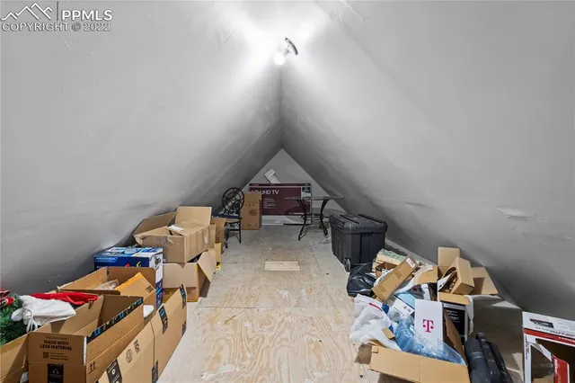 a living room with furniture and a gym equipment