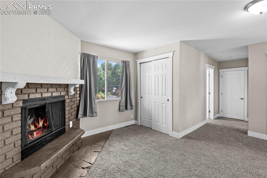 738 Harrison Place Colorado Springs, CO 80905 - Photo 16 of 25 a view of an empty room with a fireplace and window
