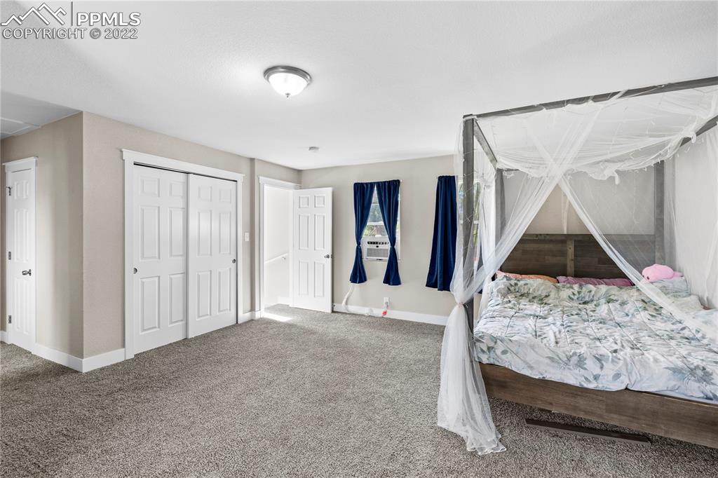 738 Harrison Place Colorado Springs, CO 80905 - Photo 18 of 25 a bedroom with a bed and a window